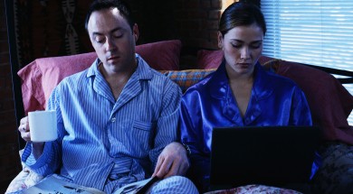 Business Couple Working in Bed