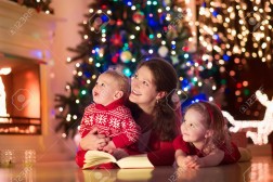 Mother and children at home on Christmas eve