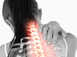 Digital composite of Highlighted spine of woman with neck pain