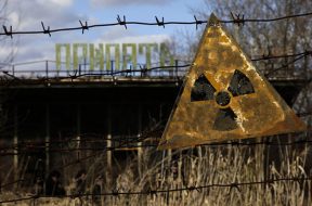 A radioactive sign hangs on barbed wire outside a café in Pripyat.